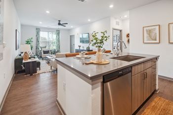 A kitchen with an island and a living room with a couch