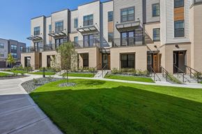 Woodbury townhouse for rent - a view of the exterior of a building with green grass at Meridian at CityPlace in Woodbury, 55125