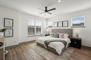 Woodbury townhouse for rent - a bedroom with a bed and a ceiling fan at Meridian at CityPlace, Woodbury, Minnesota