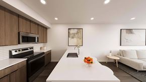 Monument apartment for rent - Open concept kitchen with white countertops and living area at The Maverick Luxury Apartments, Monument, Colorado
