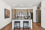 San Tan Valley apartment for rent - a kitchen with a large island with two stools and a stainless steel refrigeratorat Stella, San Tan Valley, 85143