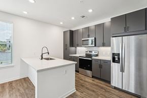 Daytona Beach apartment for rent - a kitchen with stainless steel appliances and a white counter top at Drift, Daytona Beach, FL, 32117