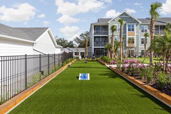 A grassy area with a sign that says h in the middle.
