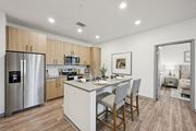 Fountain apartment for rent - a kitchen with a large island and a stainless steel refrigerator at The Garrison Luxury Apartment Homes, Colorado