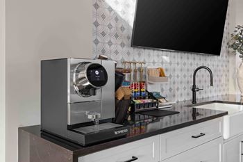 Coffee machine sits on a kitchen counter.