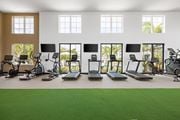 North Port triplex for rent - A gym with treadmills, exercise bikes, and other equipment.
