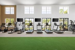 North Port triplex for rent - A gym with treadmills, exercise bikes, and other equipment.