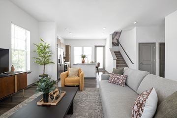 North Port triplex for rent - A living room with a grey couch and a coffee table.