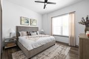 North Port triplex for rent - A bedroom with a large bed and a ceiling fan.