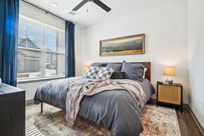 Greeley apartment for rent - a bedroom with a bed and a large window at Premier at West Park Luxury Apartment Homes, Colorado