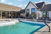 Greeley apartment for rent - a swimming pool in front of a house at Premier at West Park Luxury Apartment Homes, Greeley, CO, 80634
