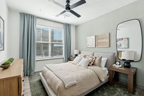 Buckeye apartment for rent - a bedroom with a large bed and a ceiling fan at The Maddox Luxury Apartment Homes, Arizona