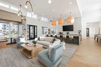 A living room with a grey sofa and a wooden coffee table