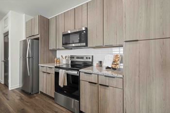 A modern kitchen with wooden cabinets and stainless steel appliances