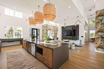 A modern kitchen with a large island and wooden floors