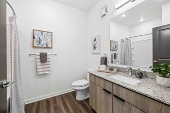 A bathroom with a white toilet and a sink