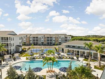A large building with a pool in front of it