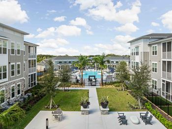 A view of a pool area with chairs and plants