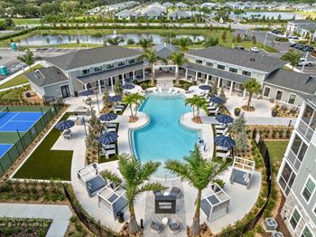 A large swimming pool surrounded by lounge chairs and umbrellas