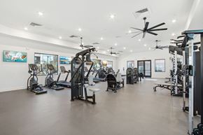 Buckeye apartment for rent - a gym with weights and cardio equipment in a building with white walls at The Maddox Luxury Apartment Homes, Buckeye Arizona
