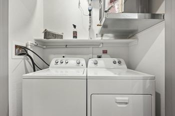 A washer and dryer in a laundry room with a sink