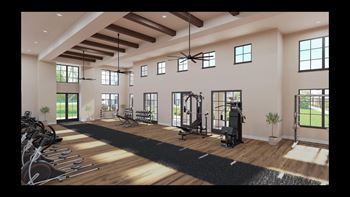 A fitness room with exercise equipment and windows