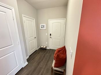 A living room with red walls and white doors