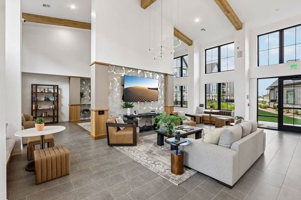 Longmont apartment for rent - A spacious living room with a large couch, a coffee table, and a fireplace.