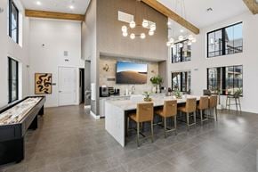 Longmont apartment for rent - A modern kitchen with a pool table and a dining table.