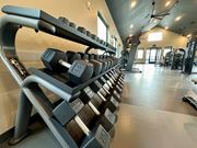 Raymore apartment for rent - a row of dumbbells in a gym at The Depot, Raymore, 64083