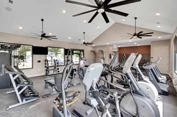 A gym with treadmills and elliptical machines