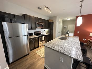 A kitchen with stainless steel appliances and granite counter tops
