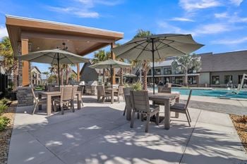 Patio with table, chairs and umbrellas