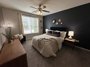 Fayetteville apartment for rent - a bedroom with a large bed and a ceiling fan at Watermark at Steele Crossing, Fayetteville, 72703
