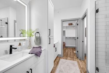 A white bathroom with a sink and a mirror
