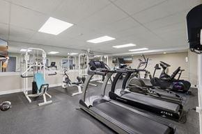 Monroeville apartment for rent - A gym with a treadmill, exercise bike, and other equipment at Birnam Wood Apartments, Monroeville, PA, 15146