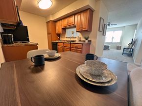 Monroeville apartment for rent - a dining room table with plates and mugs on top of it at Belmont Ridge Apartments, Monroeville, PA, 15146
