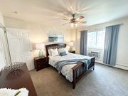 Monroeville apartment for rent - A bedroom with a large bed and a ceiling fan at Birnam Wood Apartments, Monroeville, PA, 15146