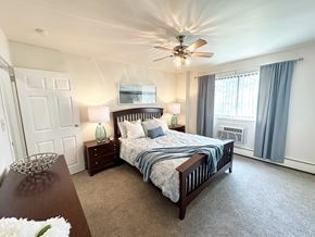 Monroeville apartment for rent - A bedroom with a large bed and a ceiling fan at Birnam Wood Apartments, Monroeville, PA, 15146