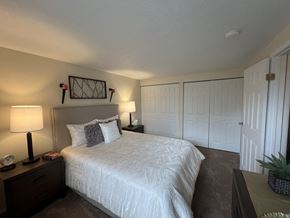 Monroeville apartment for rent - a bedroom with a large white bed and a closet at Deauville Park Apartments, Monroeville, 15146