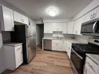 Monroeville apartment for rent - a kitchen with white cabinets and stainless steel appliances