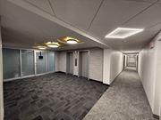 Monroeville apartment for rent - A long hallway with carpeted floors and doors on both sides.