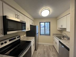 Monroeville apartment for rent - a kitchen with stainless steel appliances and white cabinets  at Deauville Park Apartments, Monroeville, PA