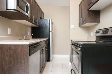 Winnipeg apartment for rent - a kitchen with a stove refrigerator and sink