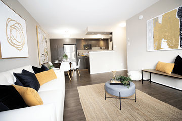 Winnipeg apartment for rent - A modern living room with a white couch and a round table in the center.