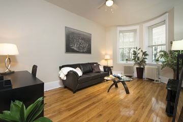 Winnipeg apartment for rent - a living room with a leather couch and a wooden floor