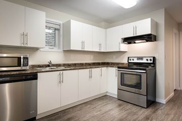 Winnipeg apartment for rent - a kitchen with stainless steel appliances and white cabinets