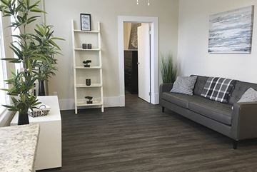 Winnipeg apartment for rent - a living room with a couch and a book shelf