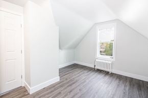 Winnipeg triplex for rent - a bedroom with hardwood floors and a white door