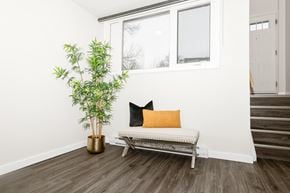 Winnipeg townhouse for rent - A room with a bench, a plant and a window.